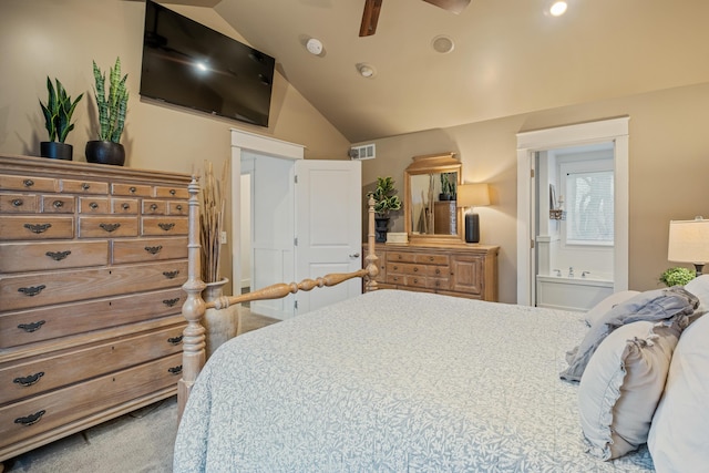 bedroom featuring ensuite bath, visible vents, and vaulted ceiling