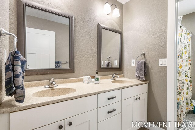 11559 Williams Rd, Montague, MI 49437 - full bath featuring double vanity, a sink, and a textured wall