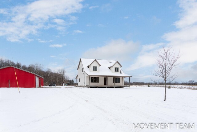 11559 Williams Rd, Montague, MI 49437 - view of front of house with a porch, an outdoor structure, and a pole building