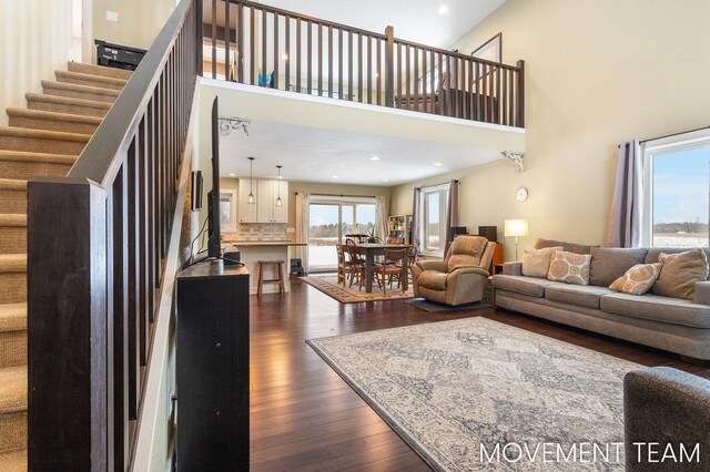 11559 Williams Rd, Montague, MI 49437 - living area featuring stairs, recessed lighting, dark wood-style floors, and a towering ceiling
