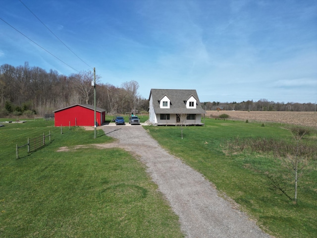 11559 Williams Rd, Montague, MI 49437 - exterior space featuring fence, an outdoor structure, driveway, and a rural view