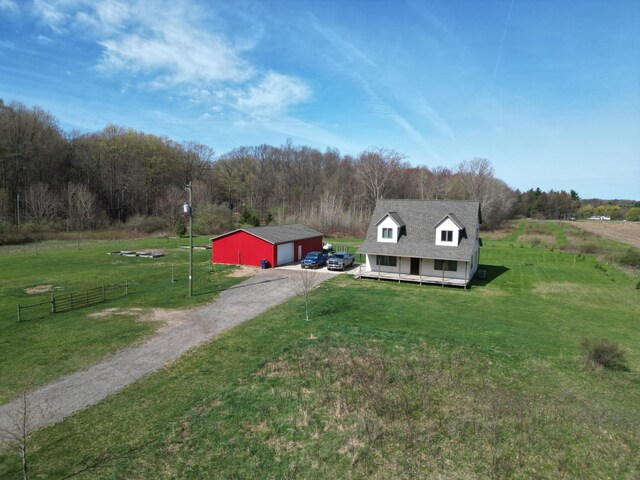 11559 Williams Rd, Montague, MI 49437 - view of front facade featuring fence, a garage, a front yard, an outdoor structure, and driveway