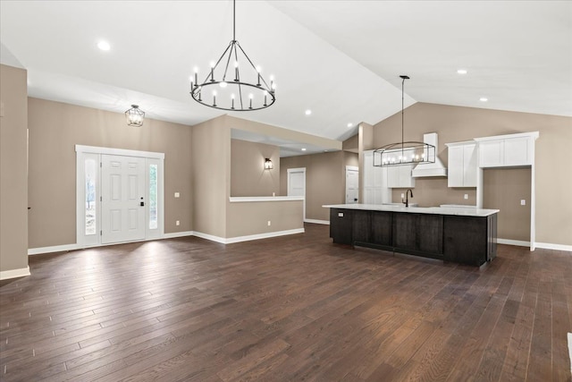 4070 Metamora Rdg, Metamora, MI 48455 - kitchen with an inviting chandelier, dark wood-style flooring, light countertops, an island with sink, and premium range hood