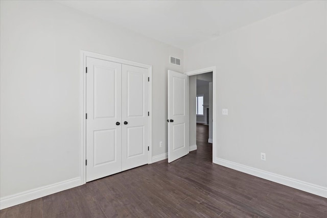 4070 Metamora Rdg, Metamora, MI 48455 - unfurnished bedroom with a closet, visible vents, dark wood-style flooring, and baseboards