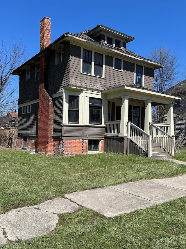190 W Buena Vista St, Highland Park, MI 48203 - view of front facade featuring a porch, a chimney, and a front lawn