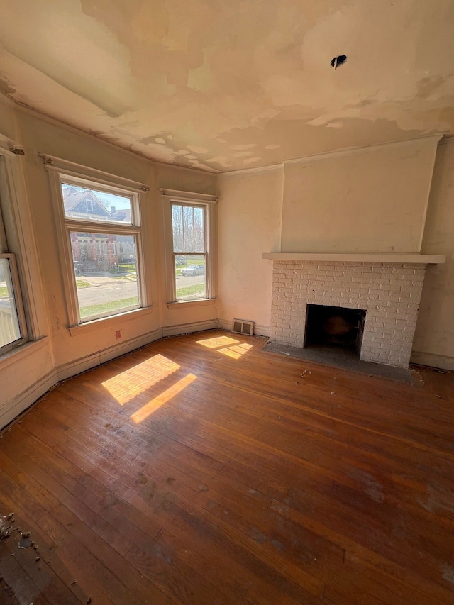 190 W Buena Vista St, Highland Park, MI 48203 - unfurnished living room with visible vents, hardwood / wood-style flooring, and a brick fireplace