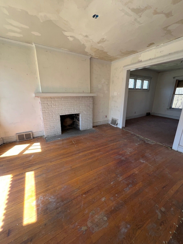 190 W Buena Vista St, Highland Park, MI 48203 - unfurnished living room with a fireplace, wood-type flooring, and visible vents