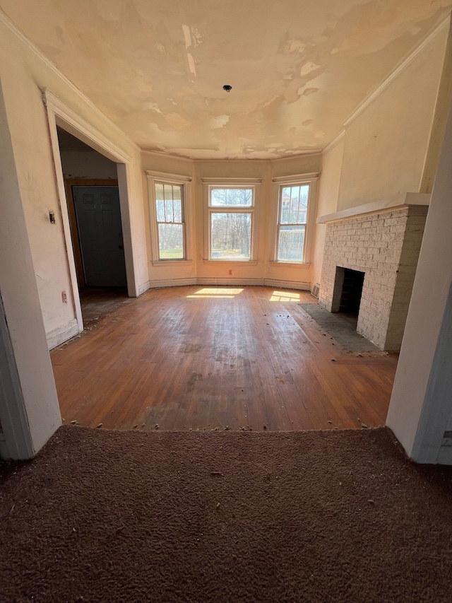 190 W Buena Vista St, Highland Park, MI 48203 - unfurnished living room with crown molding, a brick fireplace, hardwood / wood-style flooring, and baseboards