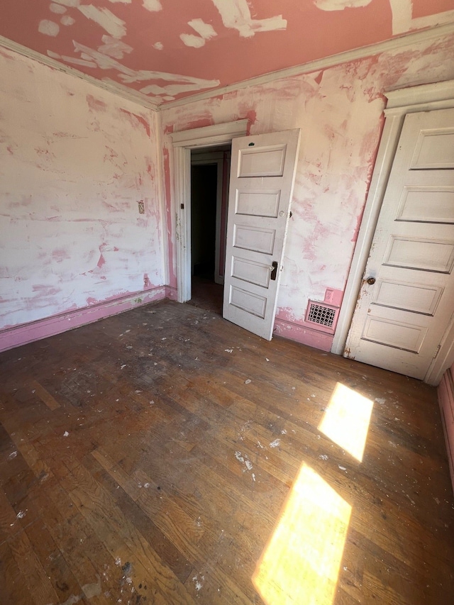 190 W Buena Vista St, Highland Park, MI 48203 - unfurnished bedroom with visible vents, hardwood / wood-style flooring, and wallpapered walls