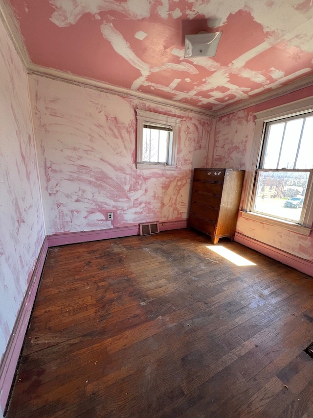 190 W Buena Vista St, Highland Park, MI 48203 - empty room featuring baseboards, wallpapered walls, crown molding, visible vents, and dark wood finished floors