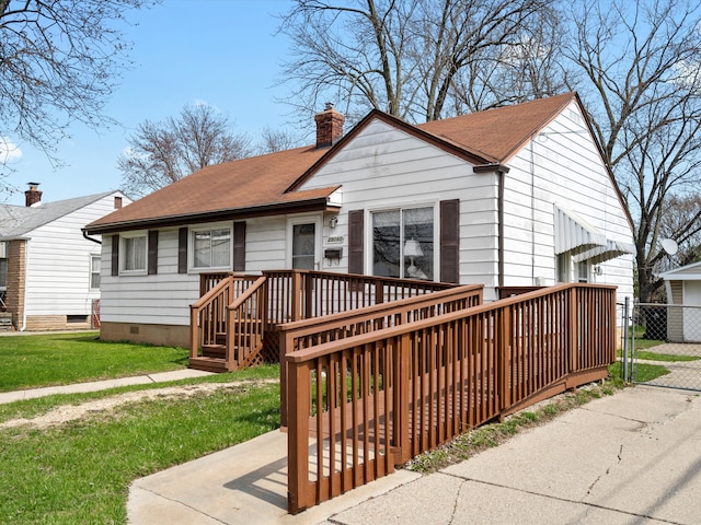 29060 Michigan St, Roseville, MI 48066 - bungalow-style house with a chimney, a shingled roof, fence, and a front lawn