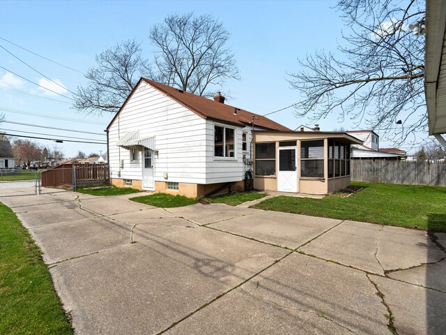 29060 Michigan St, Roseville, MI 48066 - back of house featuring a chimney, a gate, driveway, a yard, and fence
