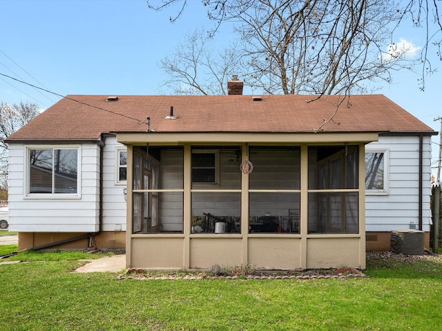 29060 Michigan St, Roseville, MI 48066 - back of house featuring a sunroom, roof with shingles, a chimney, and a lawn