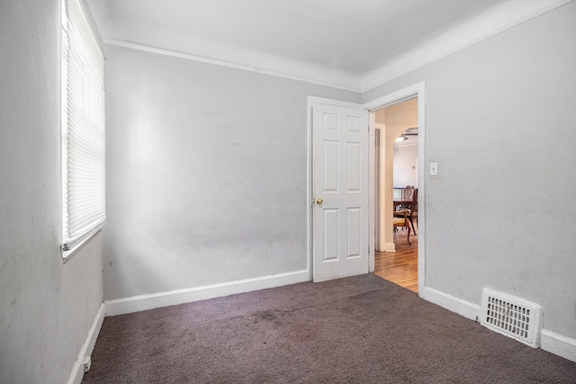 carpeted empty room with baseboards