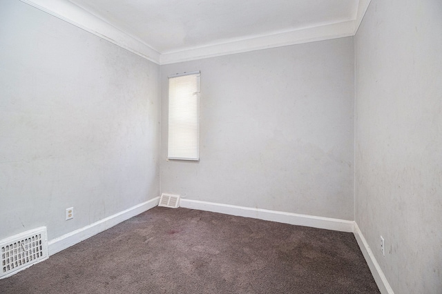 empty room featuring carpet, baseboards, and crown molding