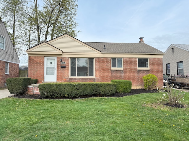 ranch-style house with brick siding and a front lawn