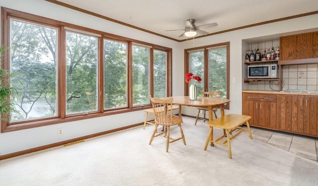 9420 Whim Trl, Richland, MI 49083 - dining space featuring ceiling fan, light carpet, ornamental molding, and baseboards