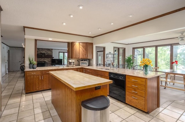 9420 Whim Trl, Richland, MI 49083 - kitchen with light tile patterned floors, wooden counters, a kitchen island, dishwasher, and a peninsula
