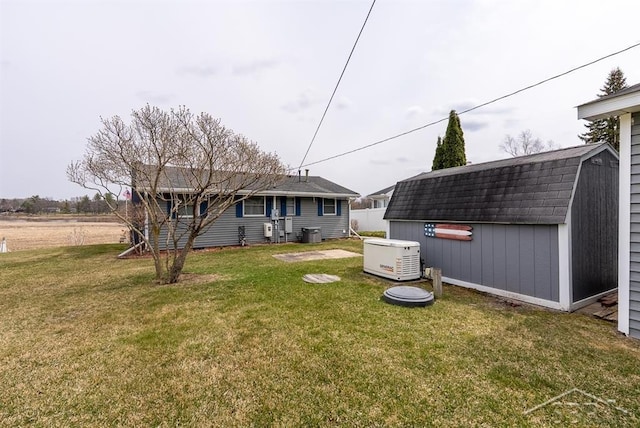 view of yard with a storage shed and an outbuilding