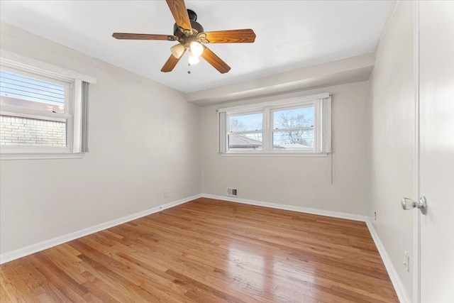 unfurnished room with ceiling fan, baseboards, light wood-style floors, and visible vents