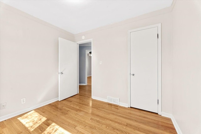 unfurnished bedroom with baseboards, visible vents, and light wood-style flooring