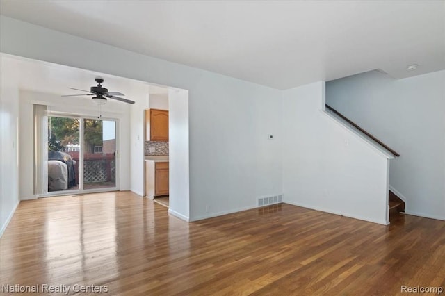 25711 Salem, Roseville, MI 48066 - unfurnished living room featuring stairway, wood finished floors, visible vents, baseboards, and ceiling fan