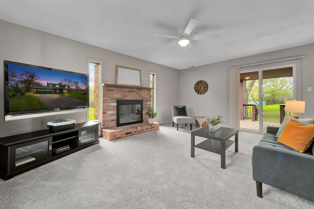 living room with carpet floors, a brick fireplace, and ceiling fan