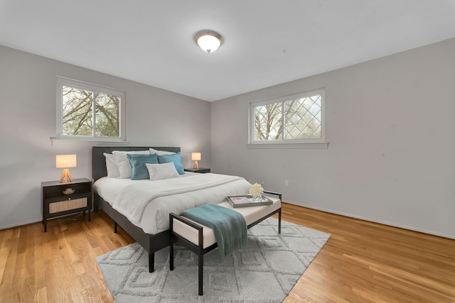 bedroom featuring baseboards and wood finished floors