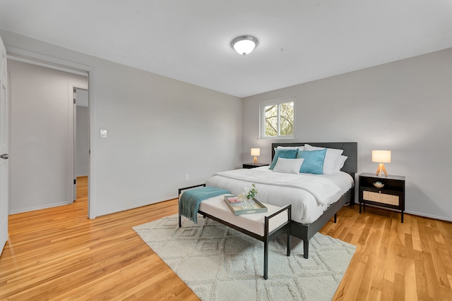 bedroom featuring baseboards and light wood-style flooring