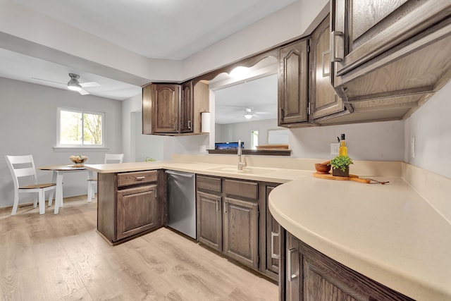 kitchen featuring light countertops, ceiling fan, light wood finished floors, and dishwasher