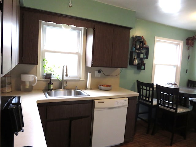 5900 Commerce Rd, West Bloomfield, MI 48324 - kitchen with light countertops, dishwasher, a sink, and dark brown cabinetry
