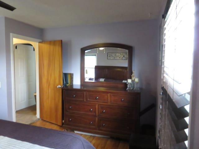 5900 Commerce Rd, West Bloomfield, MI 48324 - bedroom featuring arched walkways and wood finished floors