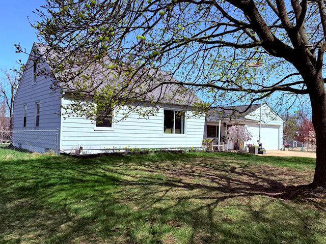 5900 Commerce Rd, West Bloomfield, MI 48324 - view of front of home featuring an attached garage, a front lawn, and concrete driveway
