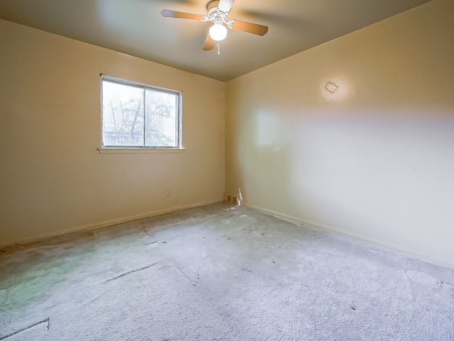 unfurnished room with light carpet, baseboards, and ceiling fan