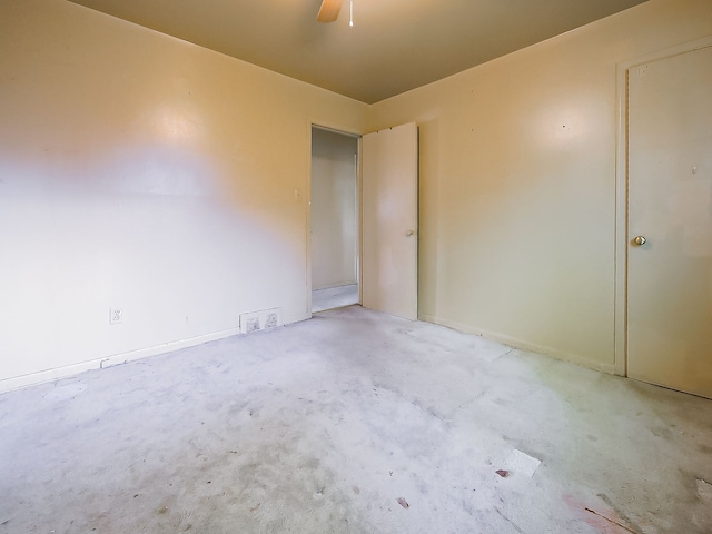spare room with baseboards and a ceiling fan