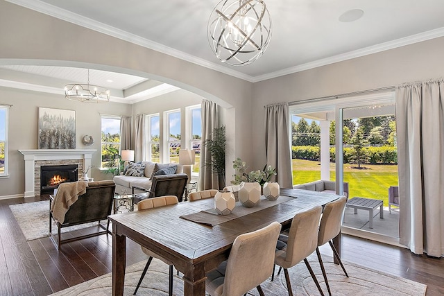 13268 Cousin, Washington, MI 48094 - dining space featuring arched walkways, an inviting chandelier, dark wood-style flooring, ornamental molding, and a glass covered fireplace