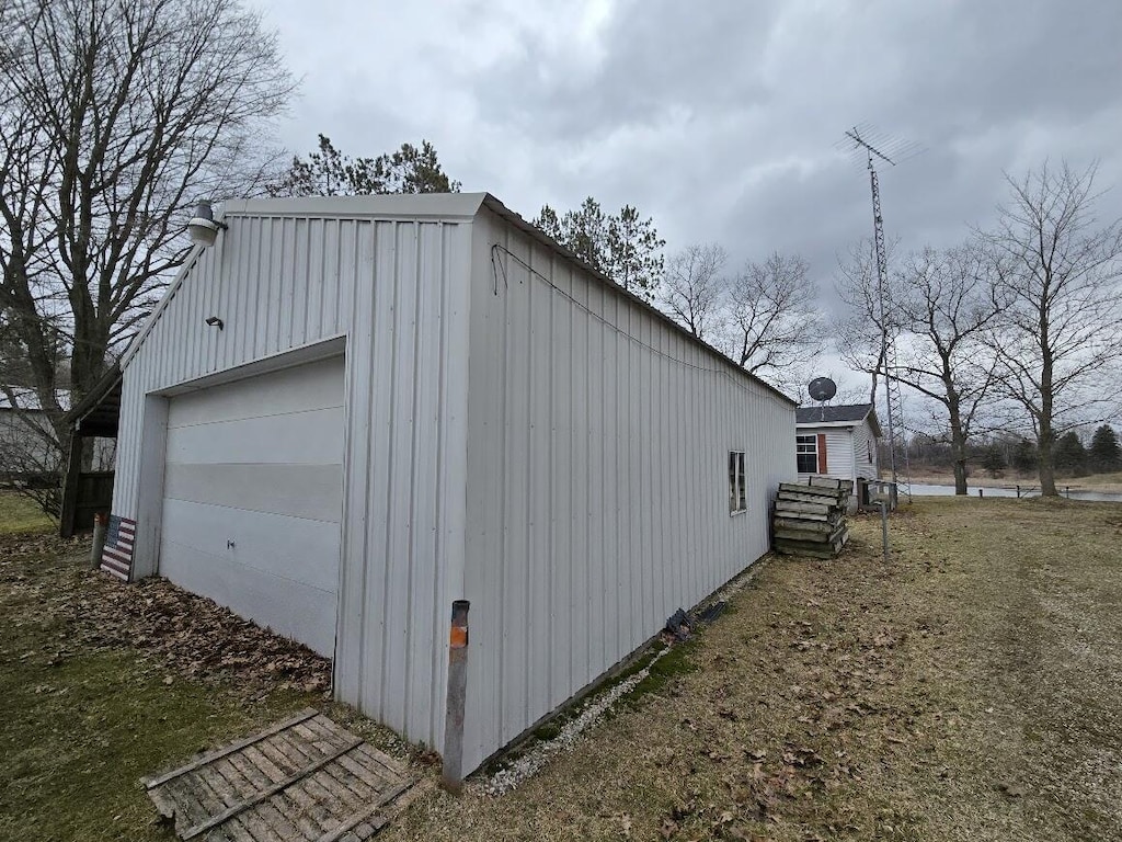 view of home's exterior with an outbuilding and a detached garage
