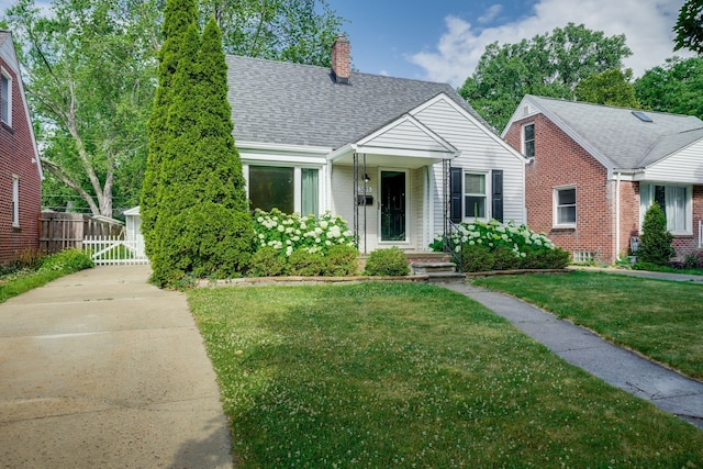 3015 N Wilson Ave, Royal Oak, MI 48073 - bungalow-style home with a chimney, brick siding, fence, a front yard, and roof with shingles