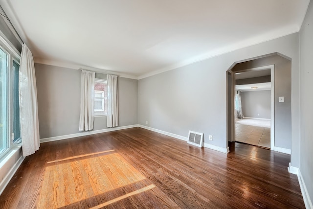3015 N Wilson Ave, Royal Oak, MI 48073 - unfurnished room with arched walkways, baseboards, visible vents, and wood finished floors
