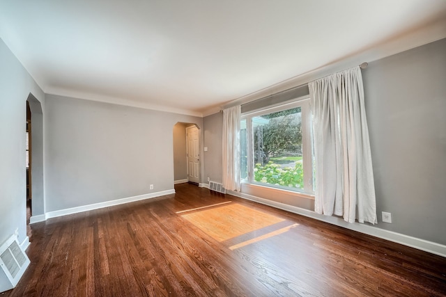 3015 N Wilson Ave, Royal Oak, MI 48073 - empty room with arched walkways, baseboards, visible vents, and wood finished floors