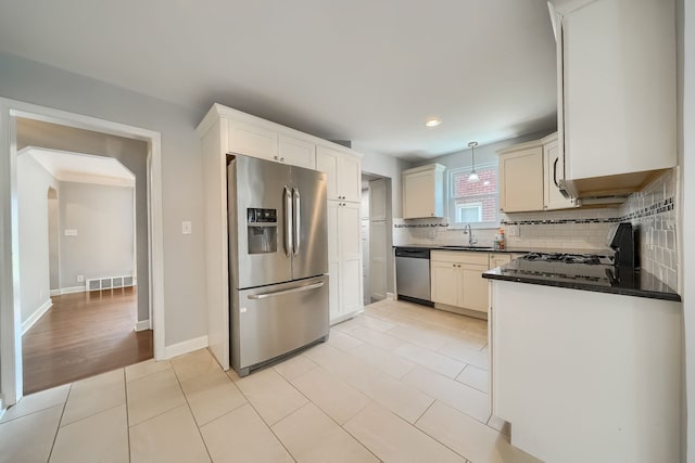 3015 N Wilson Ave, Royal Oak, MI 48073 - kitchen featuring a sink, tasteful backsplash, recessed lighting, dark countertops, and appliances with stainless steel finishes
