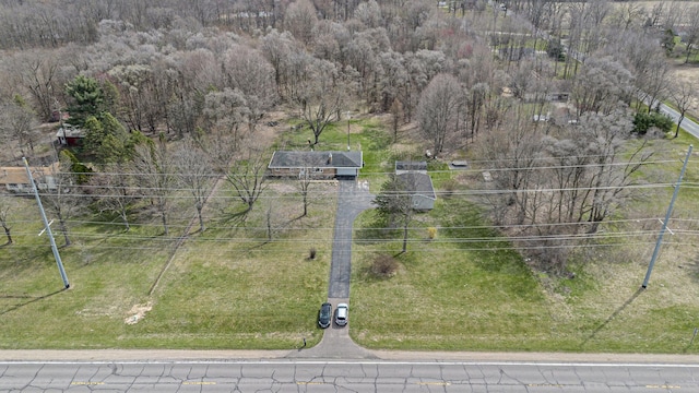 drone / aerial view featuring a view of trees