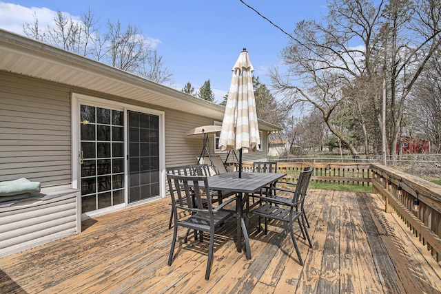 wooden deck featuring outdoor dining space and fence