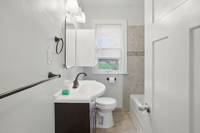 bathroom with vanity, toilet, and tile patterned flooring
