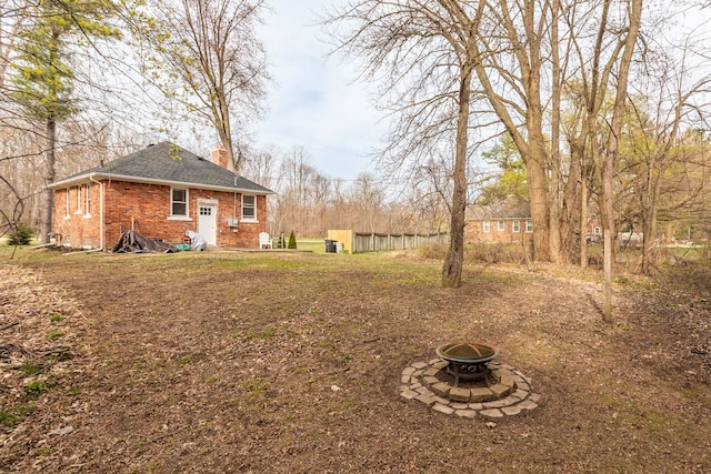view of yard with a fire pit