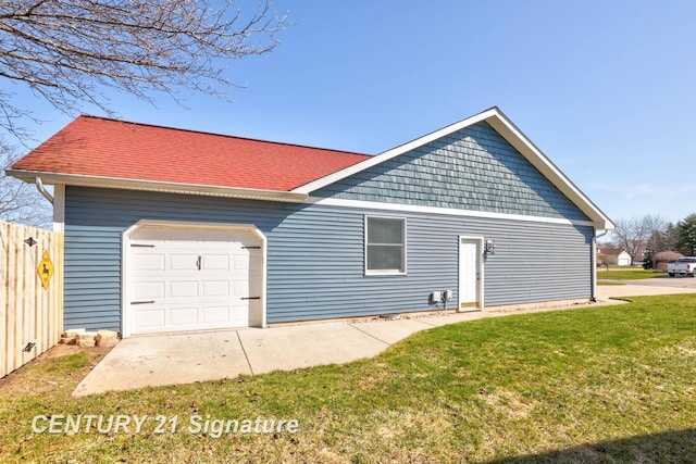 exterior space featuring a garage, a front yard, and fence
