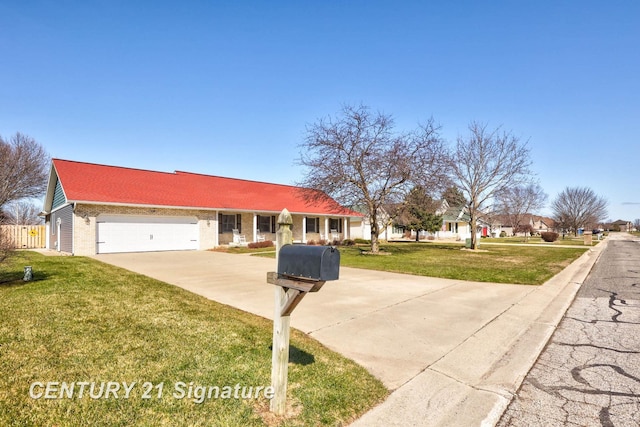 view of front of property featuring brick siding, concrete driveway, a front yard, and a garage