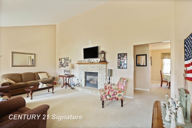 carpeted living room with a fireplace, a towering ceiling, and baseboards