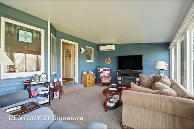 living room with a wealth of natural light, carpet flooring, and a wall unit AC