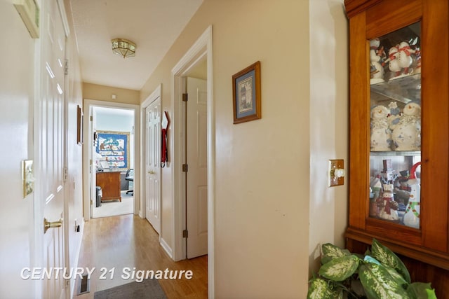 corridor featuring wood finished floors